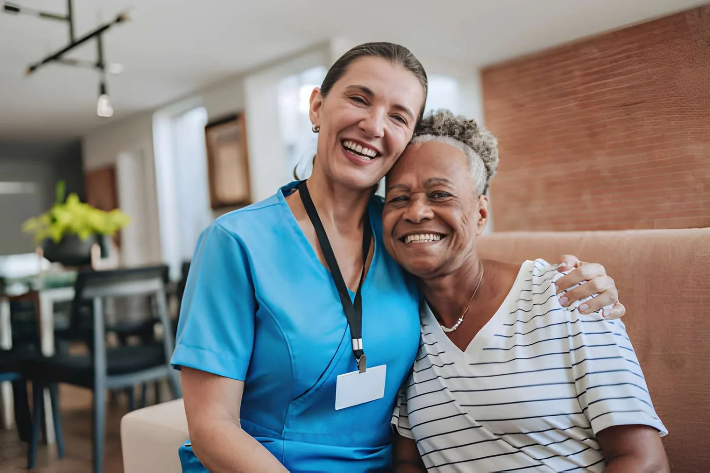 A caregiver and older adult sharing a comfortable moment at home